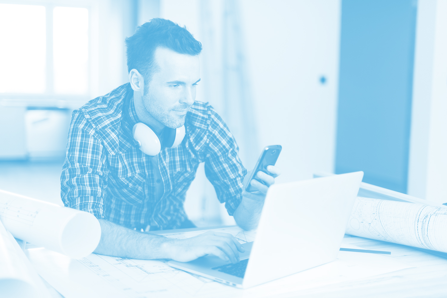 Contemporary construction worker with electronic equipment contractor using construction software